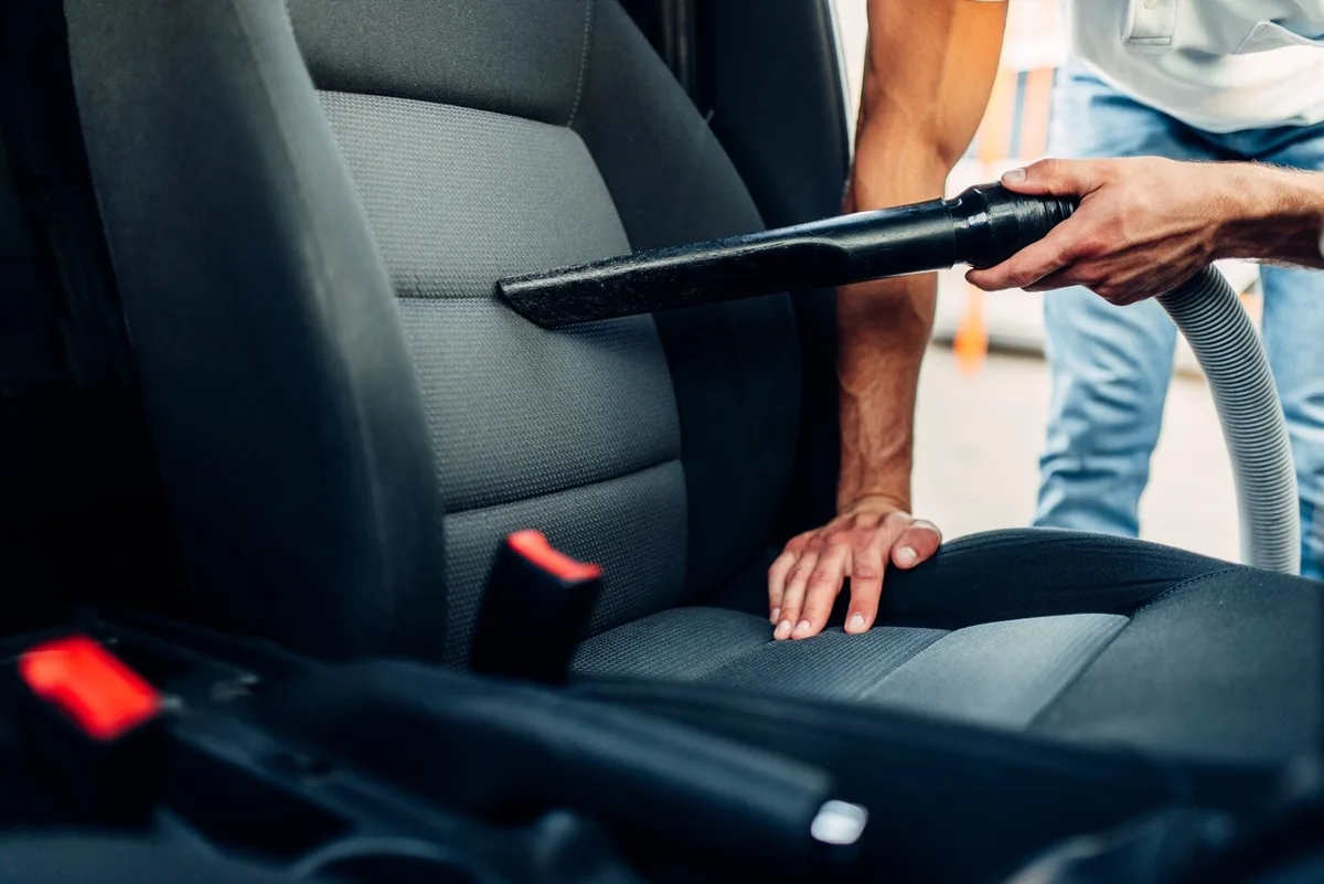 How do you vacuum under car seats?